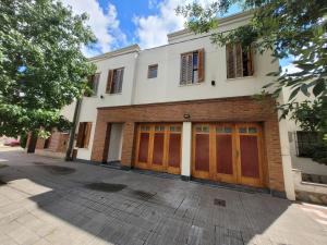 a house with two garage doors on a street at Tranquilidad en Bragado in Bragado