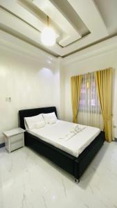 a bedroom with a bed and a window at Mira Transient in Bantay