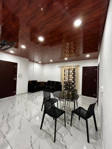 a living room with a table and chairs and a couch at brothers holidayas vagamon in Vagamon