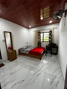 a bedroom with a bed and a desk in it at brothers holidayas vagamon in Vagamon