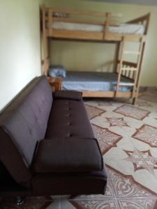 a living room with a couch and a bunk bed at Volcán Barú Unique Studio Apartment in Nueva California