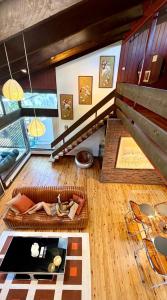 a living room with a staircase and a table at Lake front, Mid-century house with sauna 2 in Budgewoi