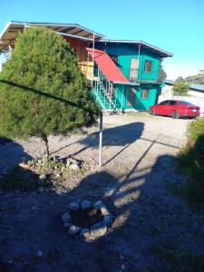a house with a red car parked in front of it at Volcán Barú Unique Studio Apartment in Nueva California