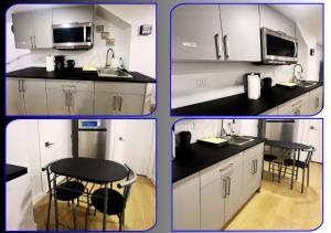 a kitchen with white cabinets and a black counter top at Bliss Haven in Winnipeg