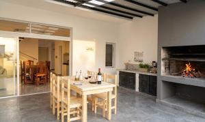 a dining room with a table and a fireplace at La soñada in Salta