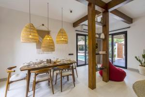 a dining room with a table and chairs at Sicilia Villa - Ubud Pool Stay with Open-Air Bath & Gazebo in Ubud