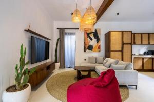 a living room with a couch and a tv at Sicilia Villa - Ubud Pool Stay with Open-Air Bath & Gazebo in Ubud +22 photos