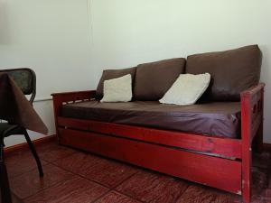 a brown couch with two pillows on it in a room at El Descanso in Las Flores +44 photos
