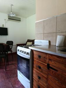 a kitchen with a stove and a counter top at El Descanso in Las Flores