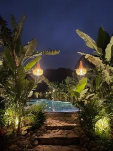 a resort with a swimming pool at night at Lamia Bamboo Retreat Ninh Binh in Ninh Binh +80 photos