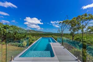 an infinity pool in a house with a view at Ocean's Edge in Cannonvale