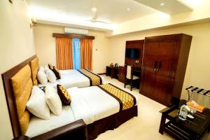 a hotel room with two beds and a cabinet at Central Inn Hotel & Spa in Dhaka