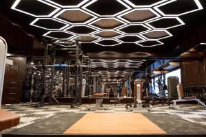 a gym with treadmills and machines in it at Central Inn Hotel & Spa in Dhaka +69 photos