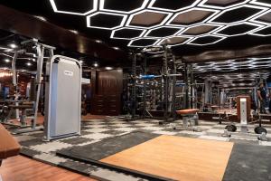 a room with a gym with machines and desks at Central Inn Hotel & Spa in Dhaka