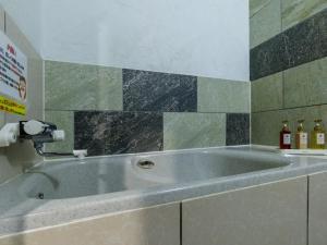 a large bath tub in a room with at Tabist ONSEN MOTEL272 in Naka-shibetsu +63 photos