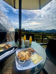a glass table with a plate of food on it at Glamping La Villa in Guatavita