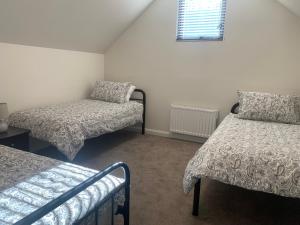a small room with two beds and a window at Keystone in Dinner Plain