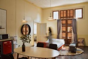 a living room with a table and a couch at Spiegel Home Studio in Semarang +14 photos