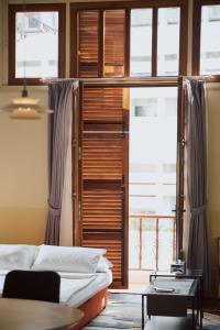 a living room with a bed and a window at Spiegel Home Studio in Semarang