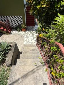 a garden with stairs and plants in front of a house at The Corinth House in Corinthe