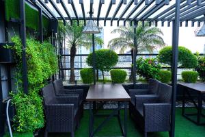 a patio with chairs and a table and plants at Central Inn Hotel & Spa in Dhaka