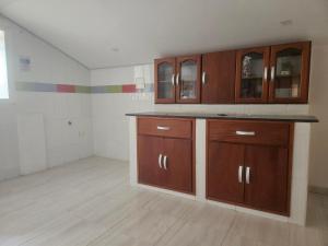 a kitchen with wooden cabinets in a room at Caribbean Airport Hotel in Cartagena de Indias +43 photos