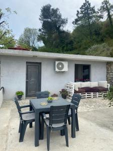 a blue table and chairs in front of a house at Tiny home at the castle in Shkodër