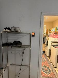 a shelf with shoes on it in a kitchen at Goodyear 2 Story Room 3 in Goodyear