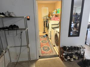 a hallway with a laundry room with a washer and dryer at Goodyear 2 Story Room 6 in Goodyear +10 photos