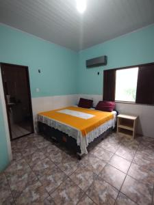 a bedroom with a bed in a room with a window at Chácara Paraíso do Mar - Araçagi in São José de Ribamar +22 photos