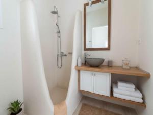 a bathroom with a sink and a shower with a mirror at Mykonos Villa for 8 with Pool in Mikonos +22 photos
