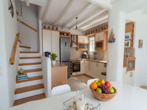 a kitchen with a bowl of fruit on a table at Mykonos Villa for 8 with Pool in Mikonos