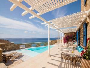 a swimming pool with a view of the ocean at Mykonos Villa for 8 with Pool in Mikonos