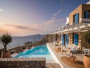 a villa with a swimming pool next to the ocean at Mykonos Villa for 8 with Pool in Mikonos
