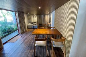 a dining room with a wooden table and chairs at Novella Tagaytay in Tagaytay