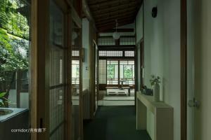 a hallway of a house with a room with windows at UTAHI  A 100-years-old Kyoto machiya in Kyoto