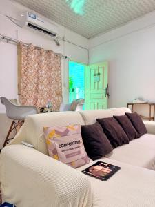 a living room with a couch with a book on it at Maculusso Hidden Gem Central & Comfortable Apartment in Luanda
