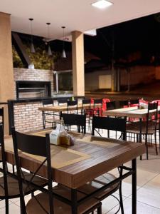 a wooden table and chairs in a restaurant at Hotel Volpi Salinas in Salinas