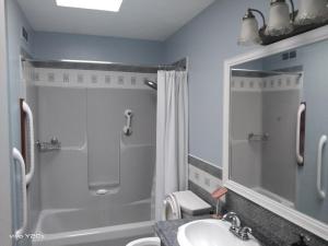 a bathroom with a shower and a sink and a mirror at Home Away From Home in Moncton +14 photos