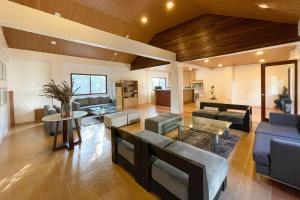 a large living room with couches and a table at Novella Tagaytay in Tagaytay