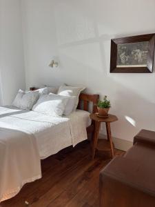 a bedroom with a white bed and a table at Timeless Villa on Parore in Dargaville +35 photos