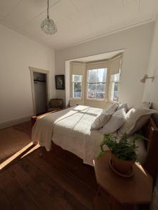a bedroom with a large bed and a window at Timeless Villa on Parore in Dargaville