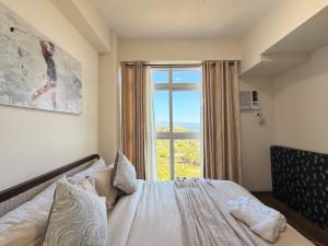 a bedroom with a bed and a large window at Serenity Ocean Garden Boracay in Boracay +50 photos