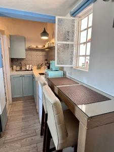 a kitchen with a table and chairs in a room at Le Petit Bonheur - Peaceful Rooftop - 3 min Beach in Puerto Vallarta