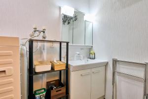 a small kitchen with a sink and a refrigerator at Furano Noie in Furano +38 photos