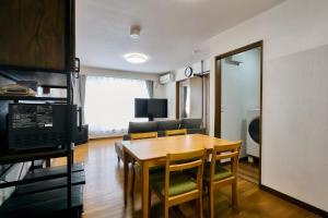 a kitchen and dining room with a table and chairs at Furano Noie in Furano