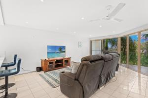 a living room with a couch and a table at The Crabpot in Airlie Beach