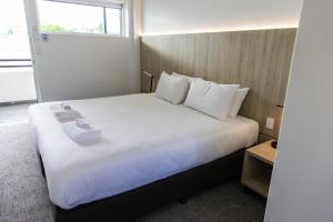 a bedroom with a large bed with white sheets and pillows at The Royal Casino in Casino