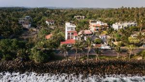 an aerial view of houses on a hill next to a waterfall at Rockvin BnB in Midigama East