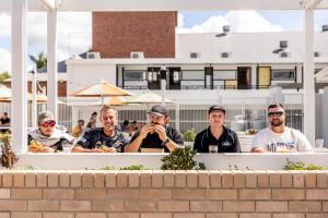 a group of men sitting behind a wall at The Royal Casino in Casino